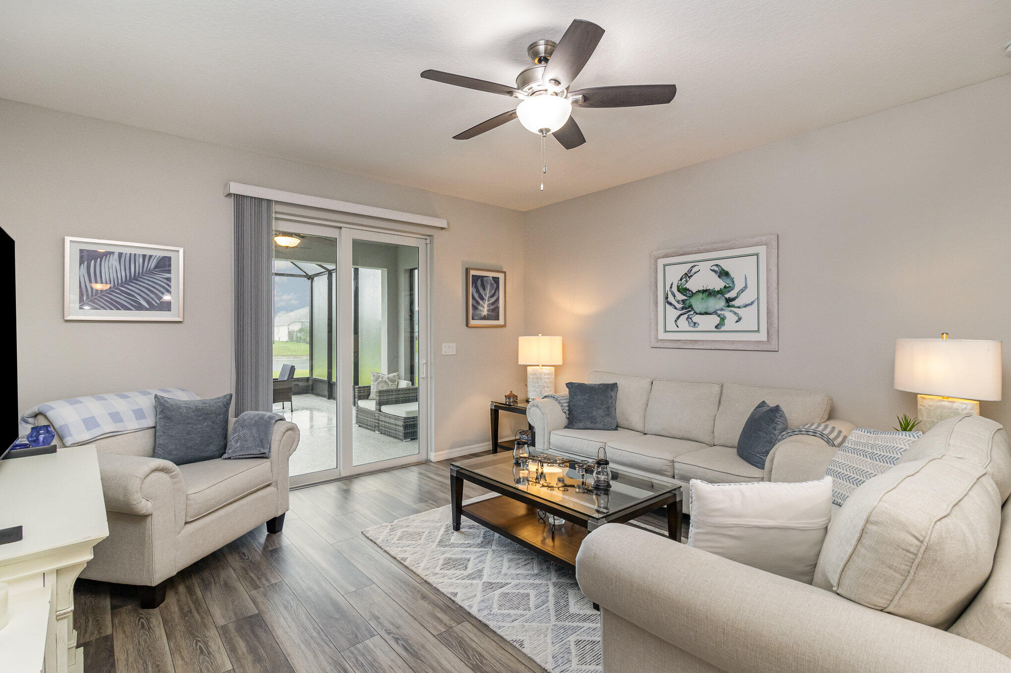 8512 Laguna Circle Micco, FL 32976 - Photo 6 of 24 a living room with furniture ceiling fan and a window