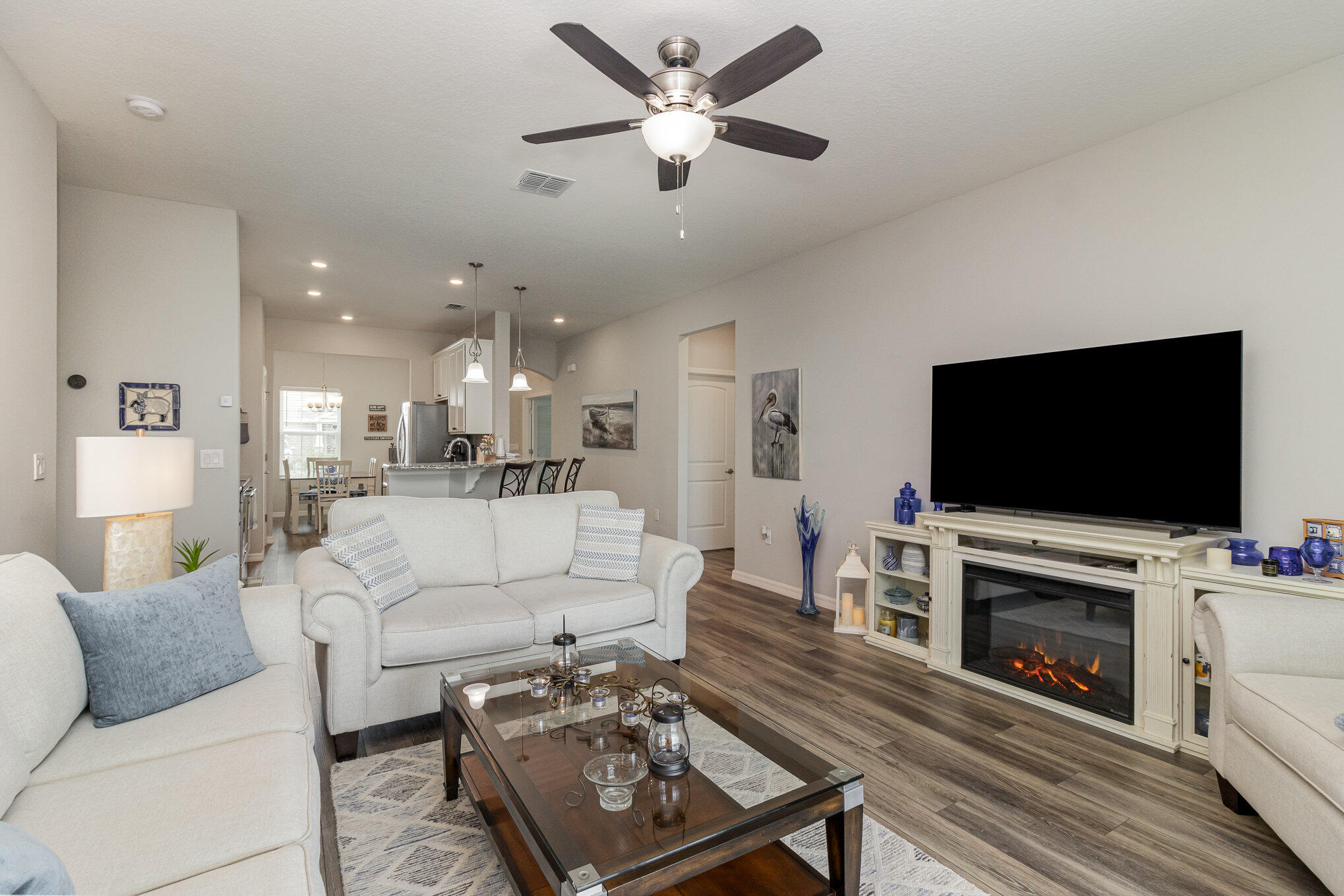8512 Laguna Circle Micco, FL 32976 - Photo 23 of 24 a living room with furniture a flat screen tv and a fireplace
