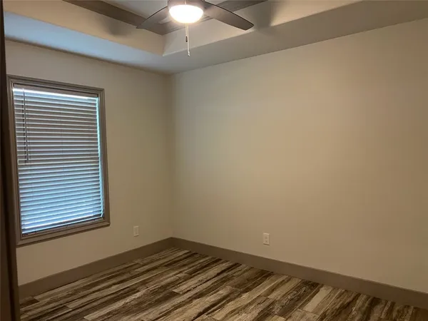 an empty room with a chandelier fan