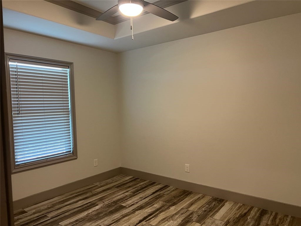 5375 County Road 73A, Unit C45 Robstown, TX 78380 - Photo 2 of 9 an empty room with a chandelier fan