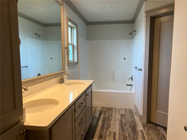 a bathroom with a tub sink and mirror