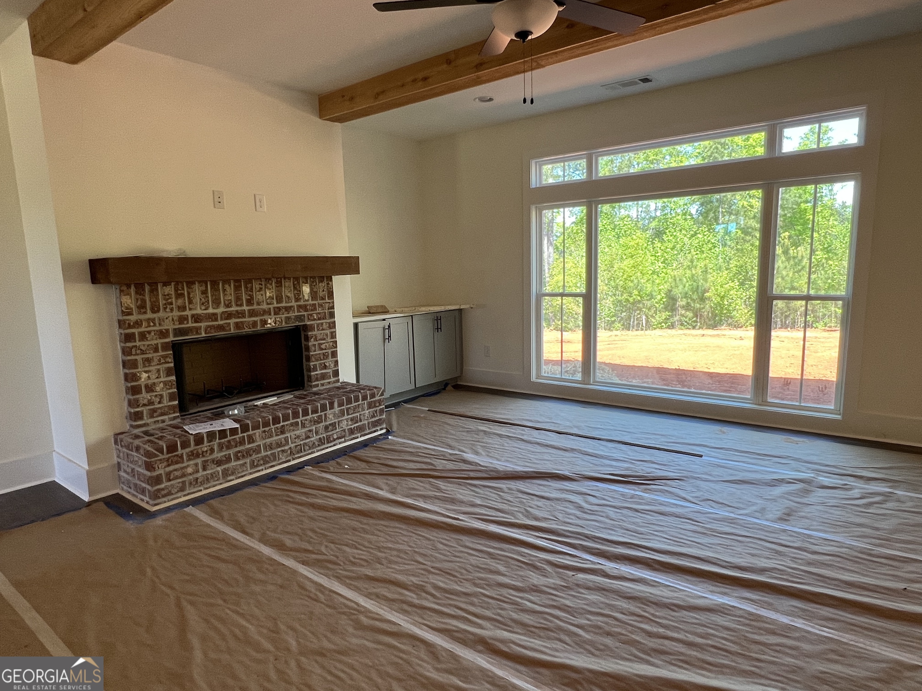 131 Hawthorne Lane Forsyth, GA 31029 - Photo 12 of 31 a living room with furniture and a fireplace