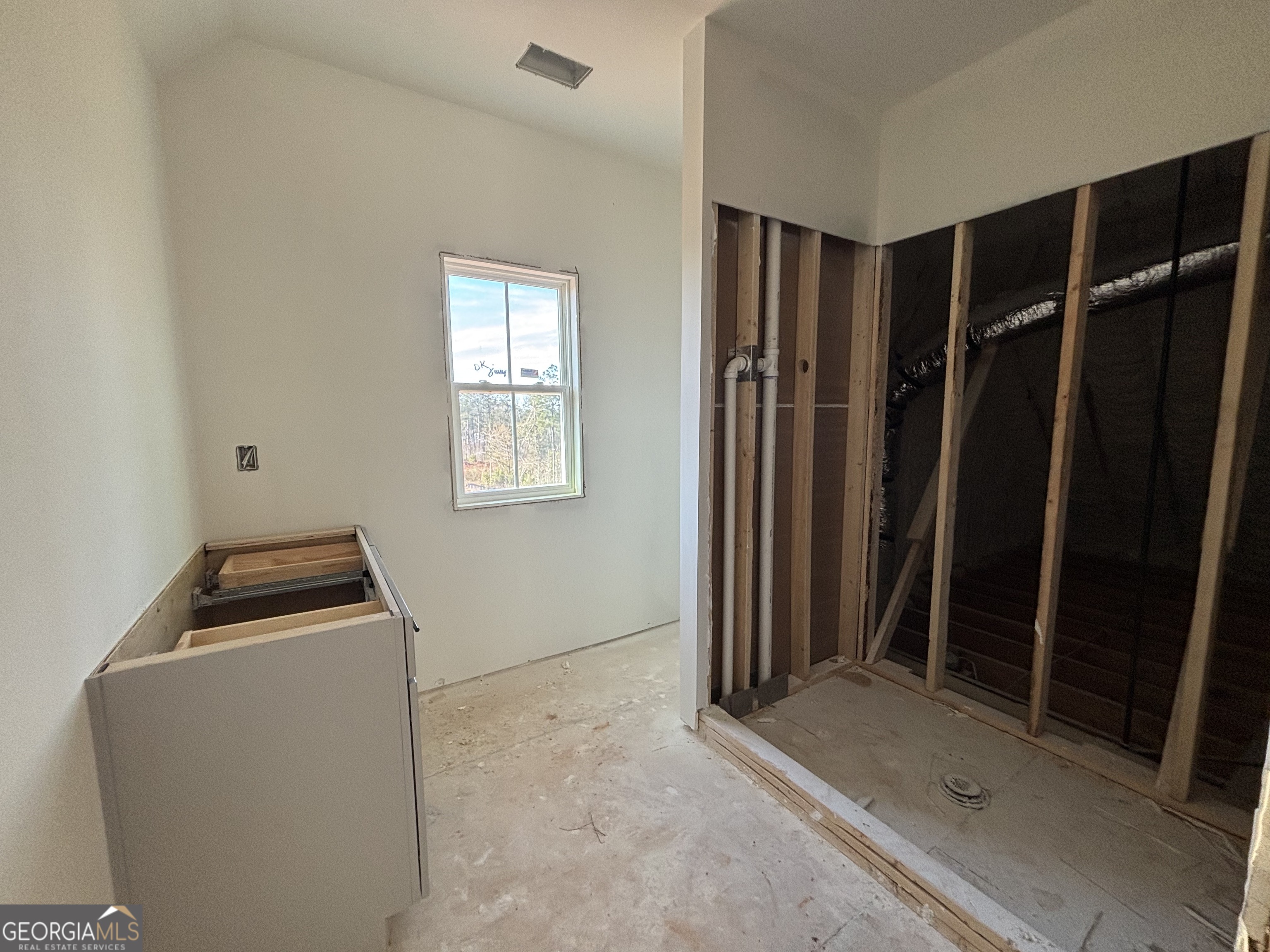 131 Hawthorne Lane Forsyth, GA 31029 - Photo 13 of 14 a view of walk in closet with clothes and window