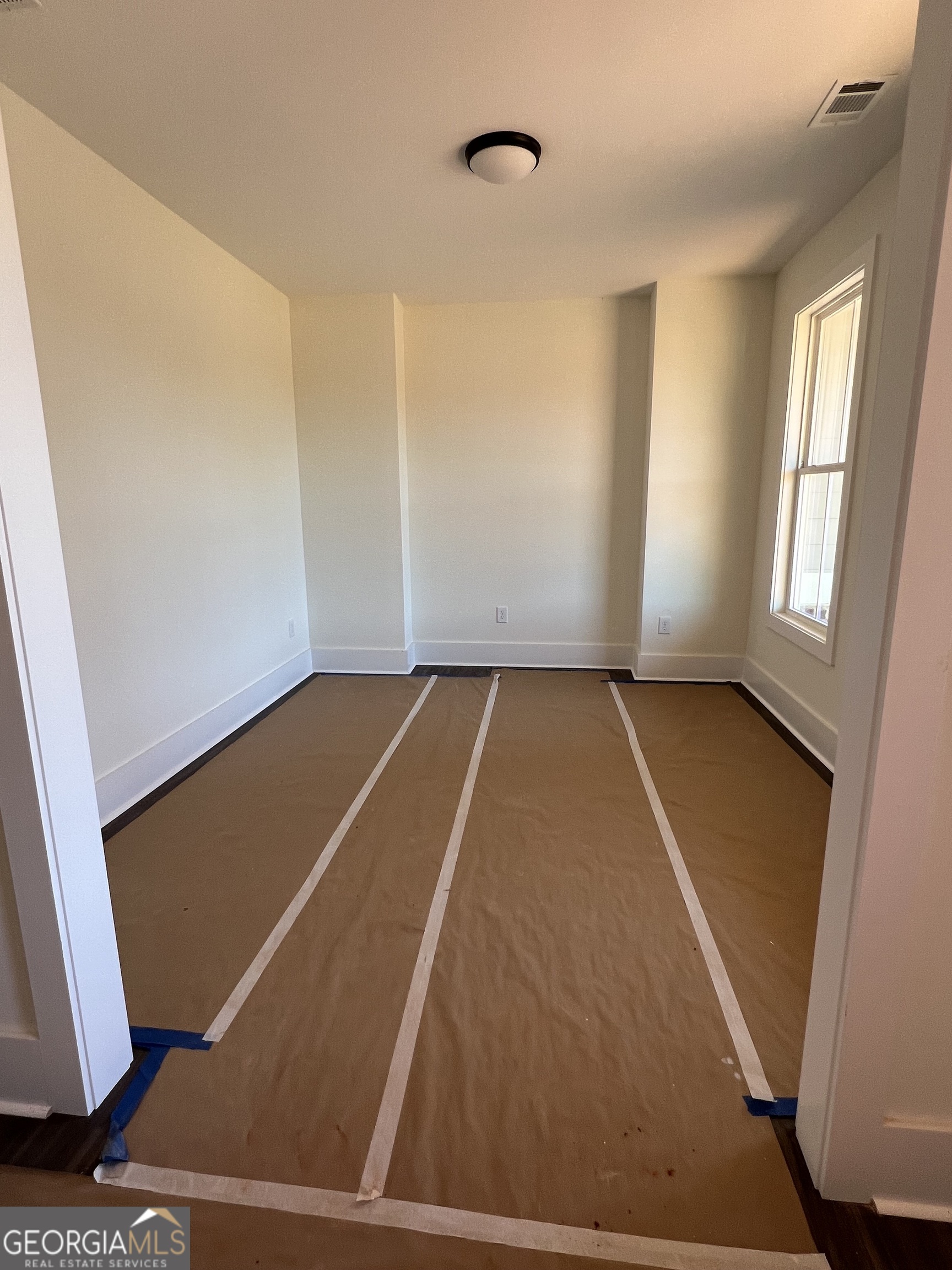 131 Hawthorne Lane Forsyth, GA 31029 - Photo 13 of 31 an empty room with windows