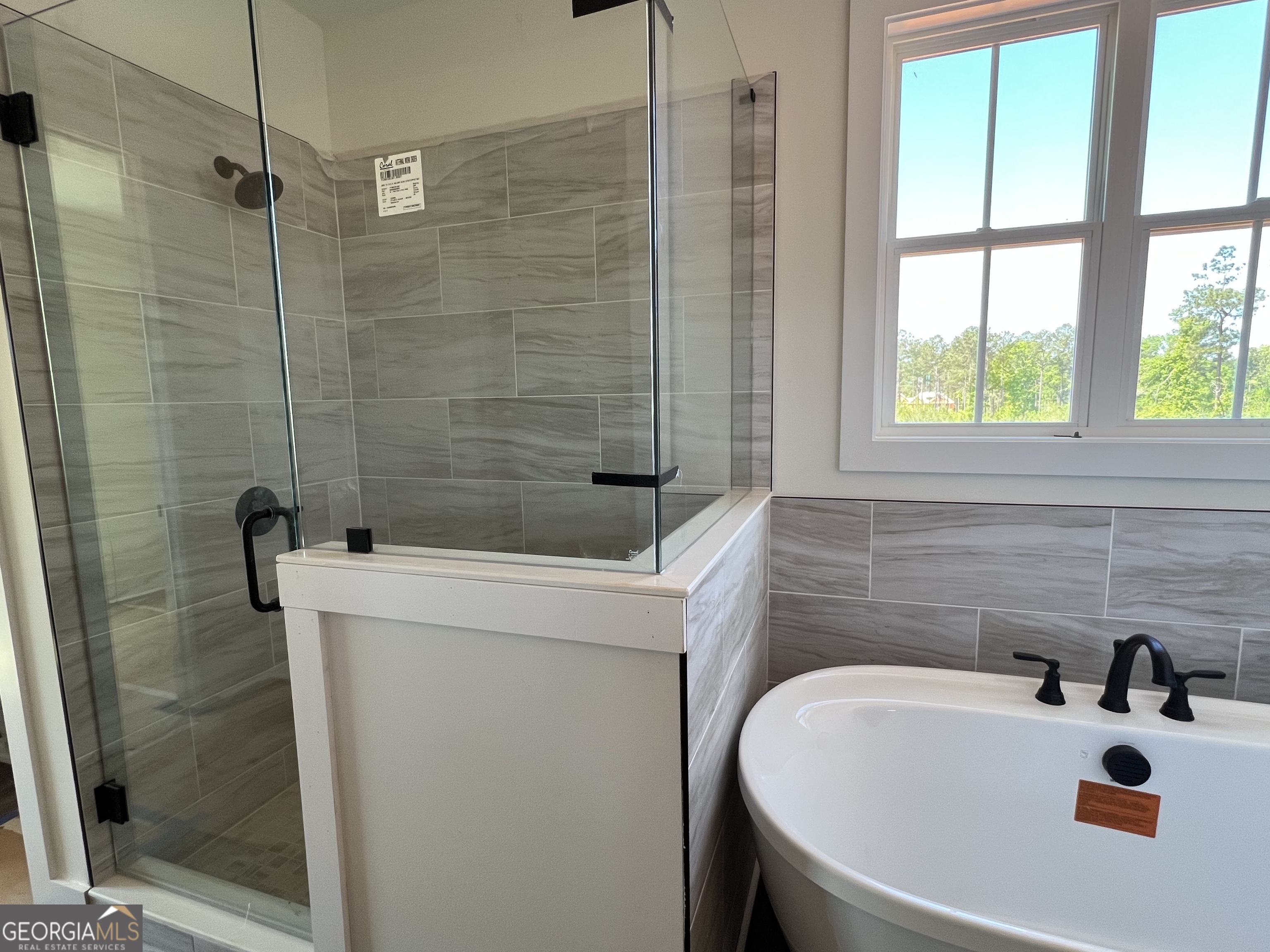 131 Hawthorne Lane Forsyth, GA 31029 - Photo 16 of 31 a bathroom with a sink and a window