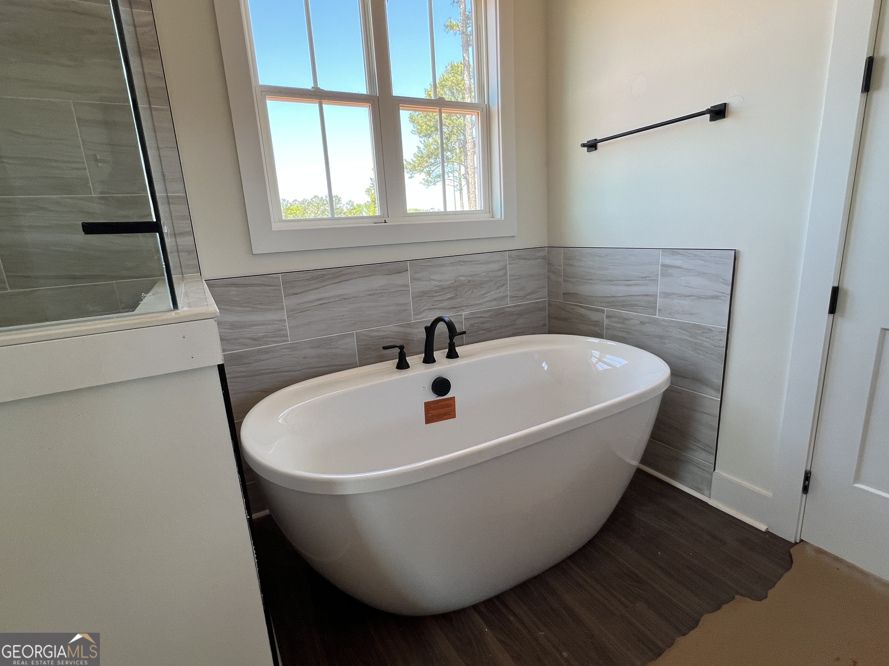 131 Hawthorne Lane Forsyth, GA 31029 - Photo 17 of 31 a white bath tub sitting in a bathroom next to a window