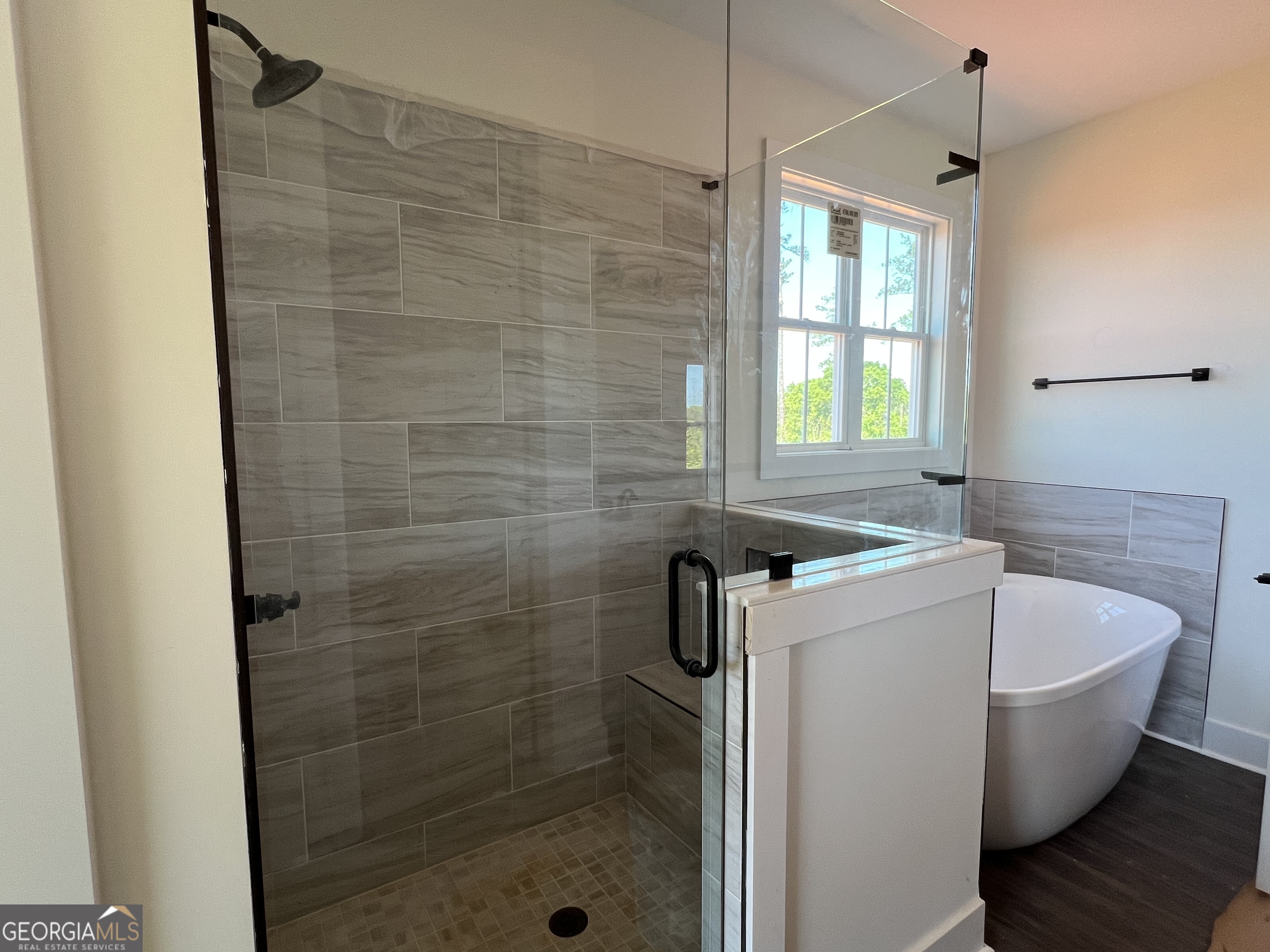 131 Hawthorne Lane Forsyth, GA 31029 - Photo 18 of 31 a bathroom with a bathtub and shower