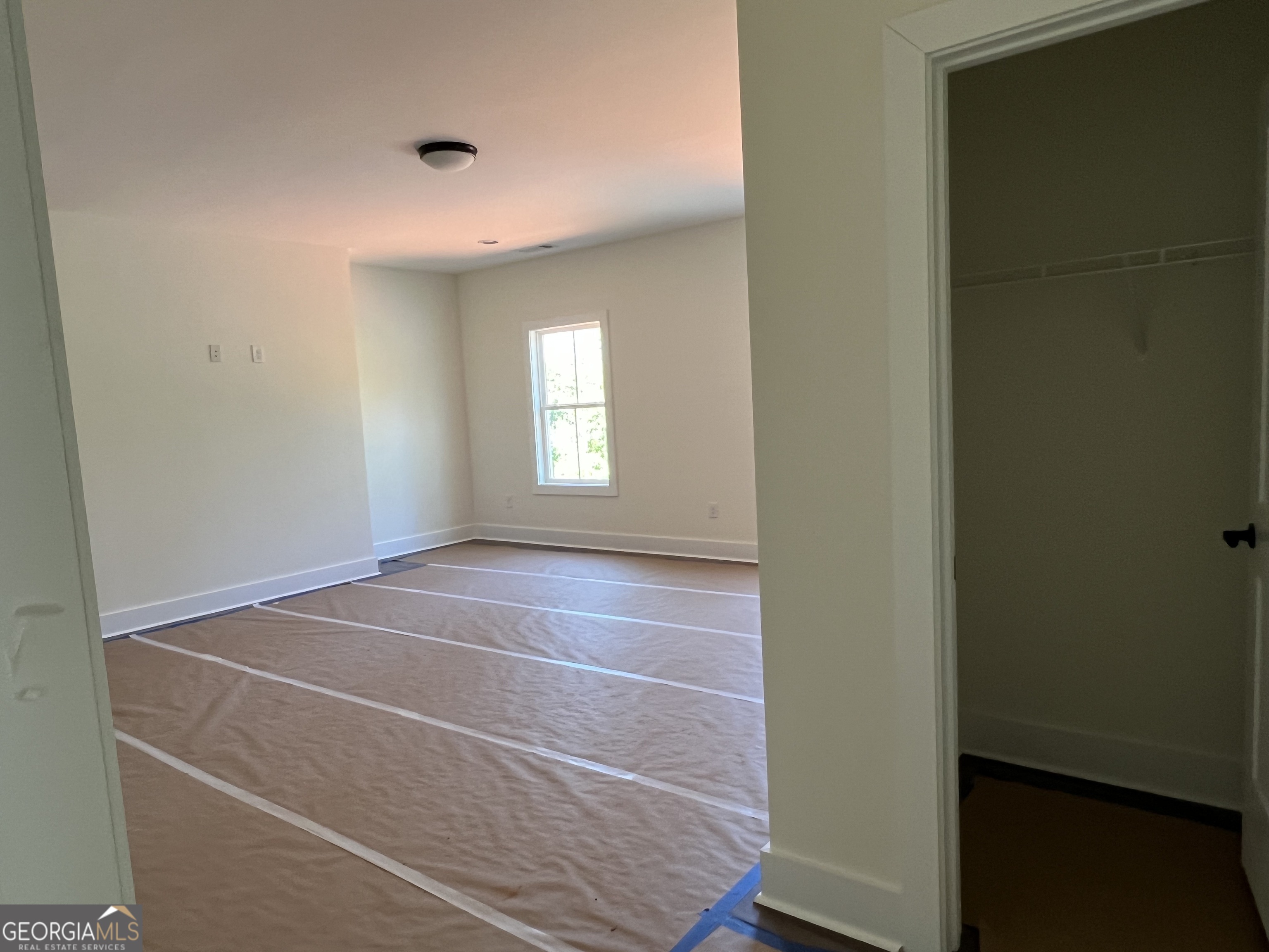 131 Hawthorne Lane Forsyth, GA 31029 - Photo 21 of 31 a room with a window and chandelier fan