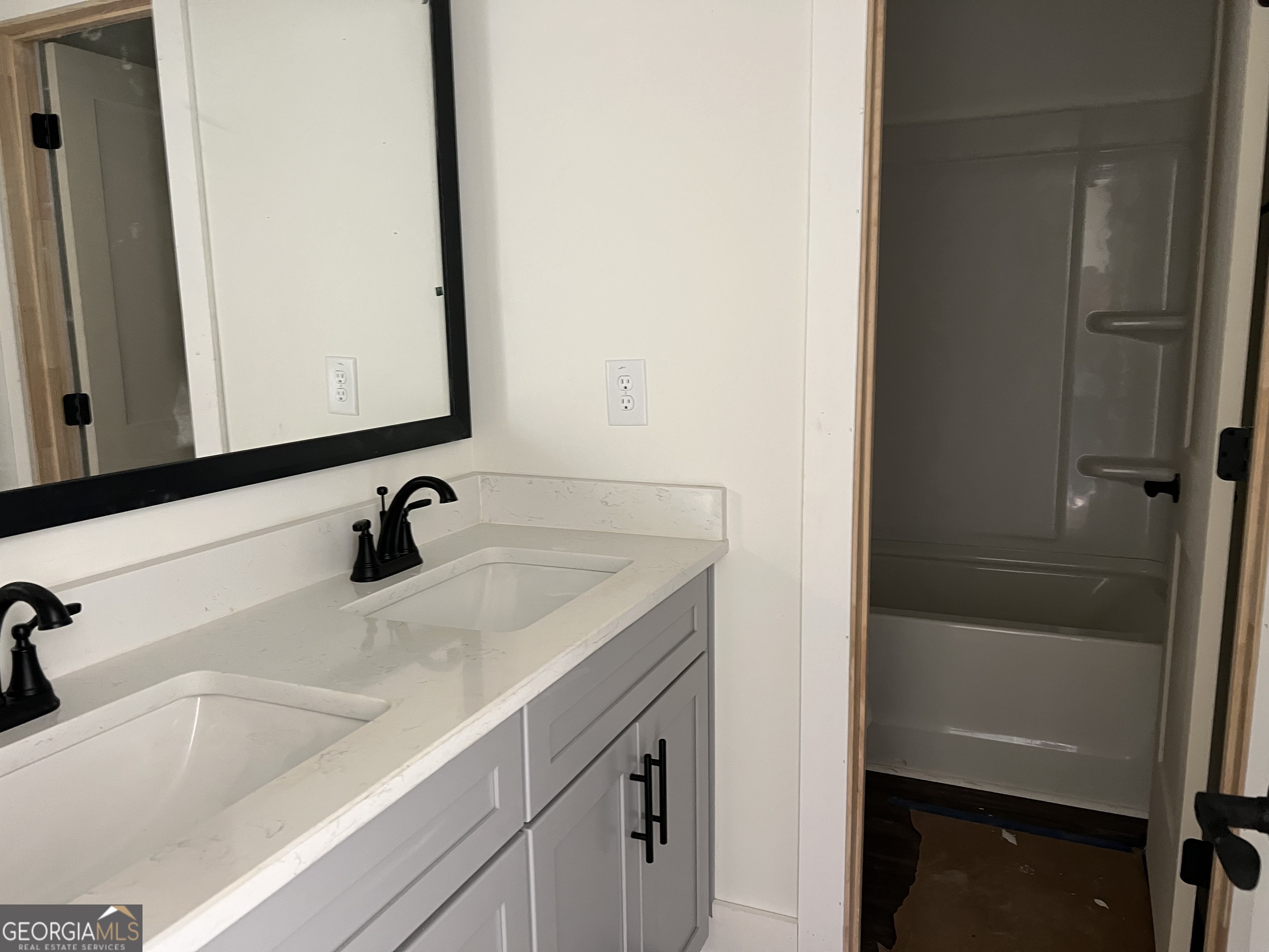 131 Hawthorne Lane Forsyth, GA 31029 - Photo 28 of 31 a bathroom with a sink and a mirror