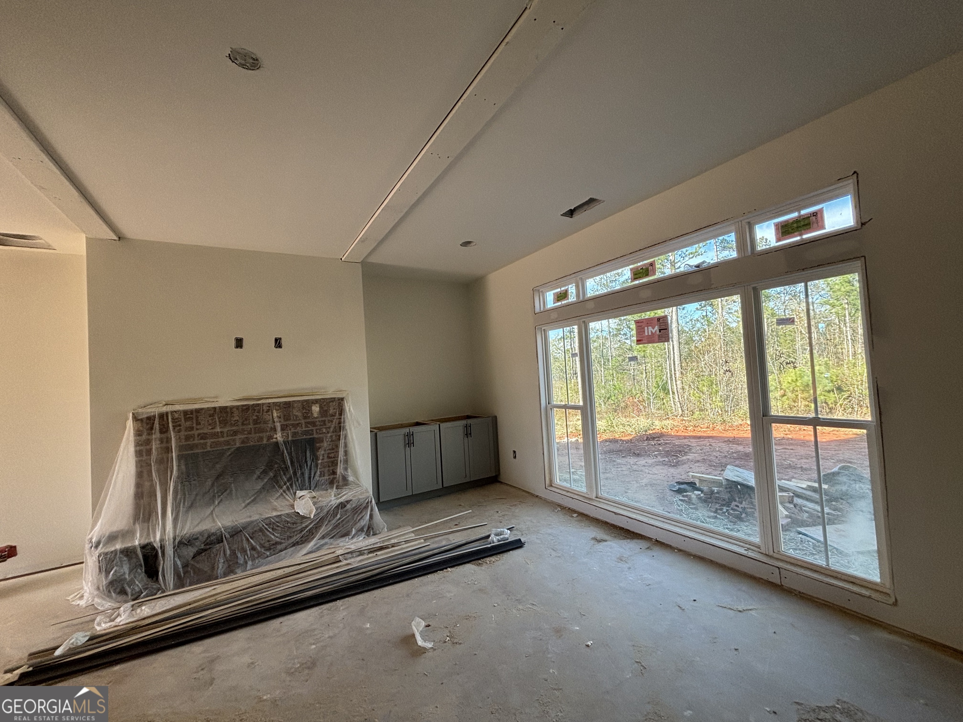 131 Hawthorne Lane Forsyth, GA 31029 - Photo 7 of 14 a livingroom with furniture wooden floor and a floor to ceiling window