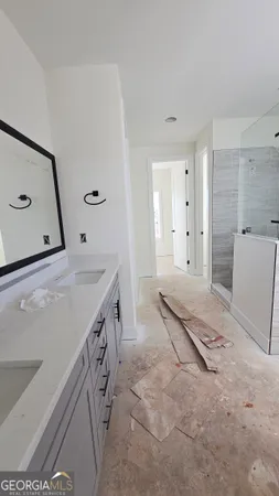 a spacious bathroom with a sink and a mirror