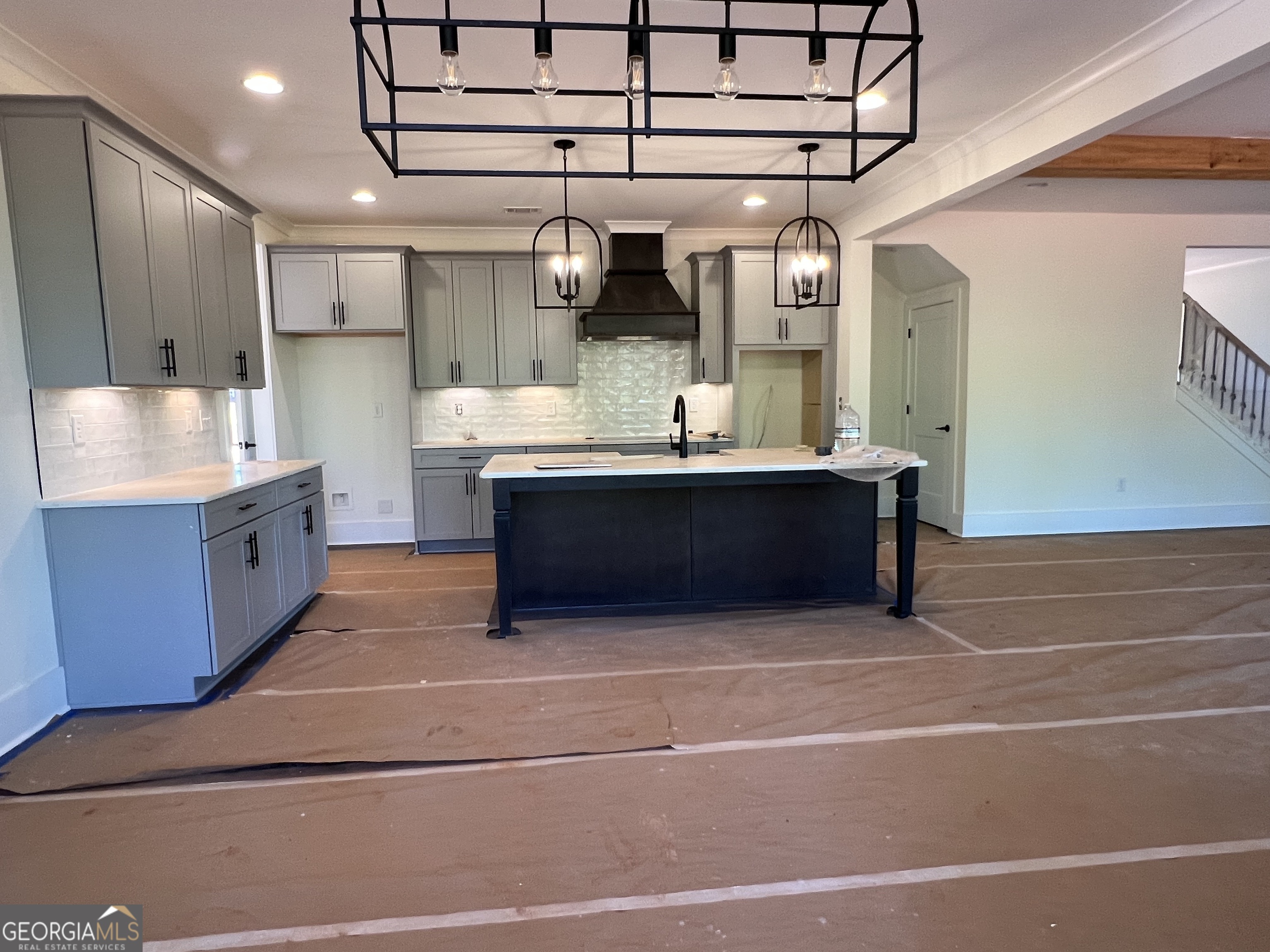 131 Hawthorne Lane Forsyth, GA 31029 - Photo 8 of 31 a large kitchen with stainless steel appliances a sink and cabinets