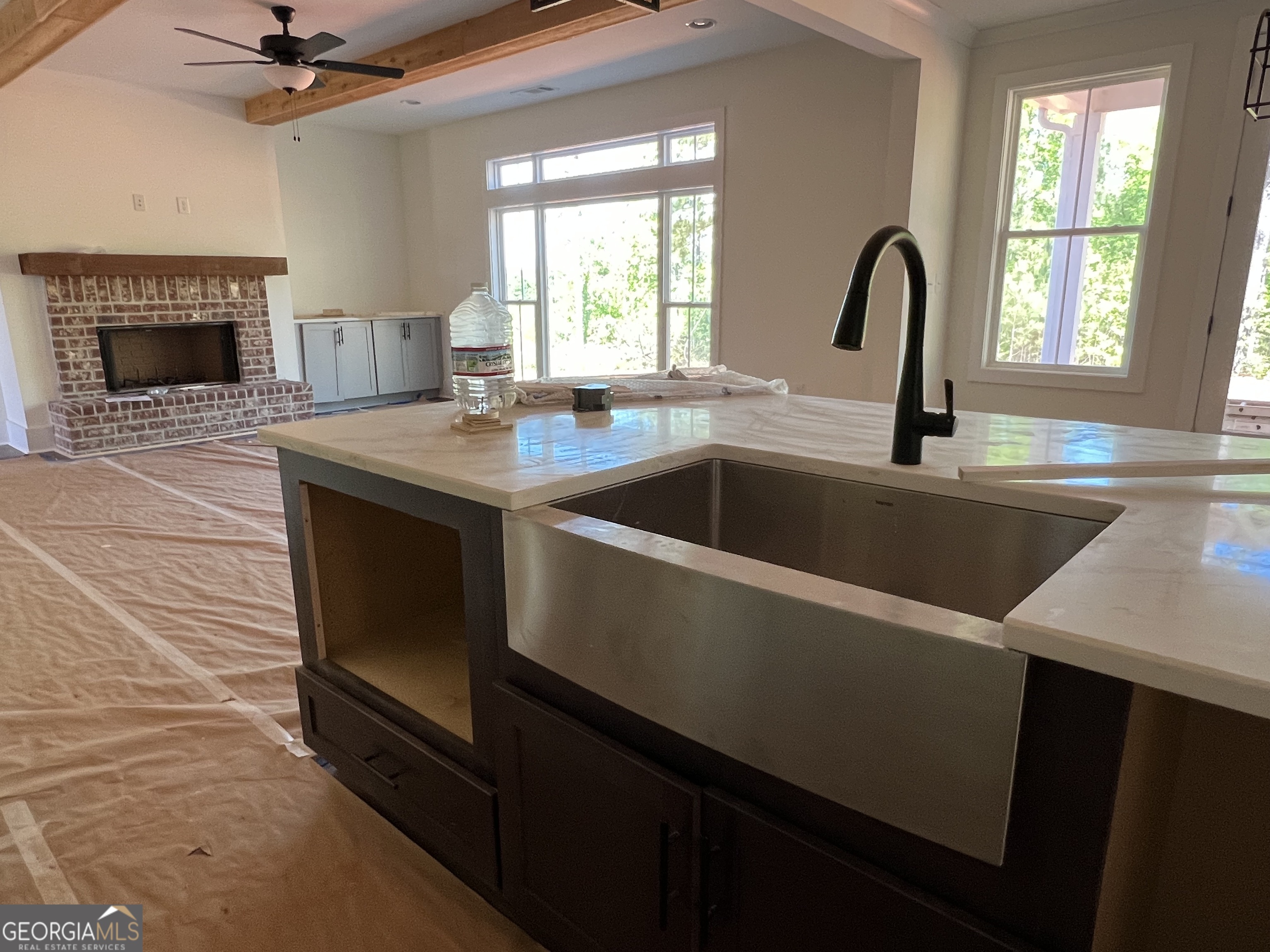 131 Hawthorne Lane Forsyth, GA 31029 - Photo 10 of 31 a kitchen with a sink and a fireplace