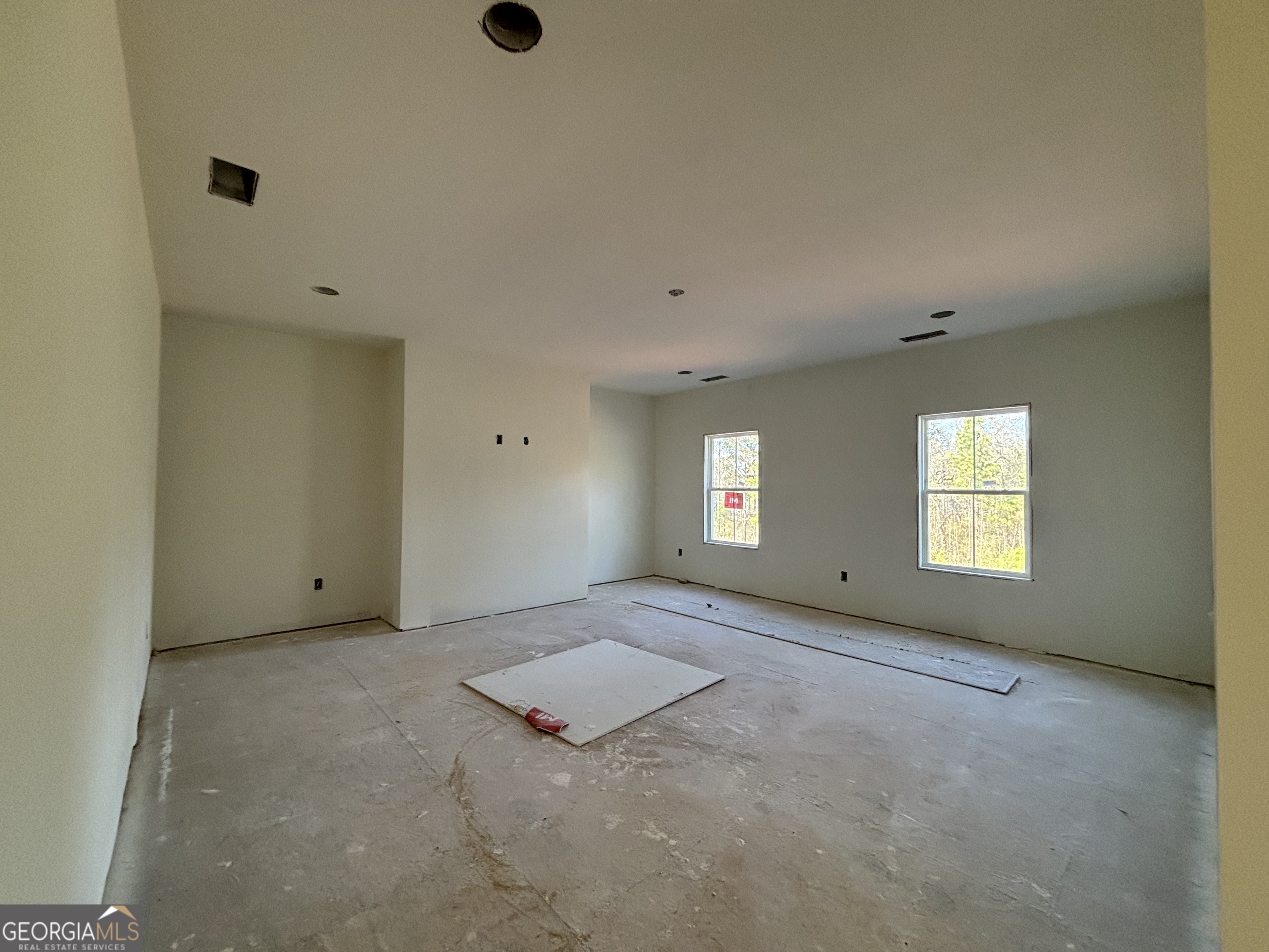 131 Hawthorne Lane Forsyth, GA 31029 - Photo 10 of 14 an empty room with windows and closet