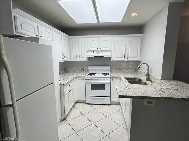 a kitchen with cabinets appliances and a sink