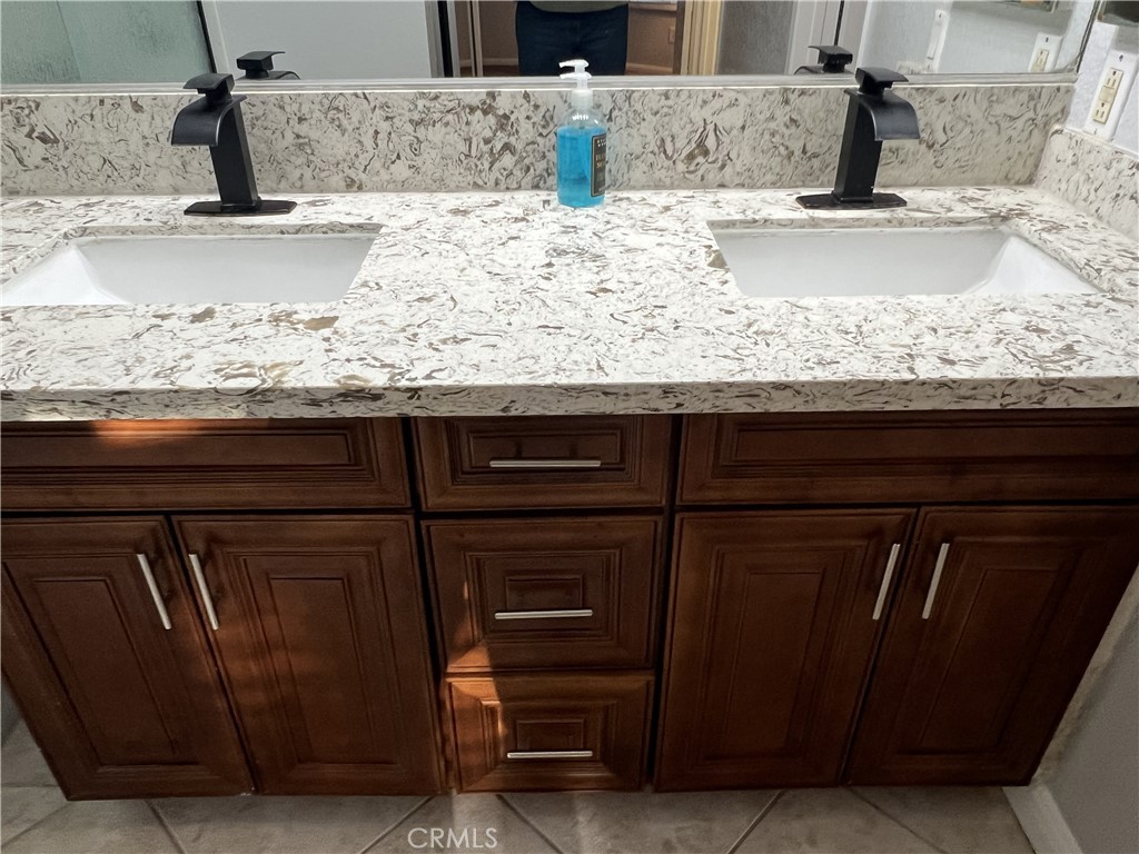 85 Castano Rancho Santa Margarita, CA 92688 - Photo 19 of 35 a kitchen with granite countertop a sink and a stove