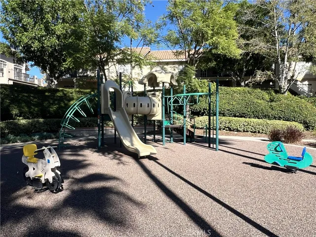 a view of a swimming pool with a patio and backyard