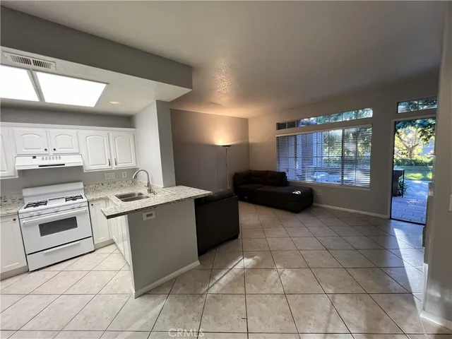 a kitchen with a sink and a stove top oven