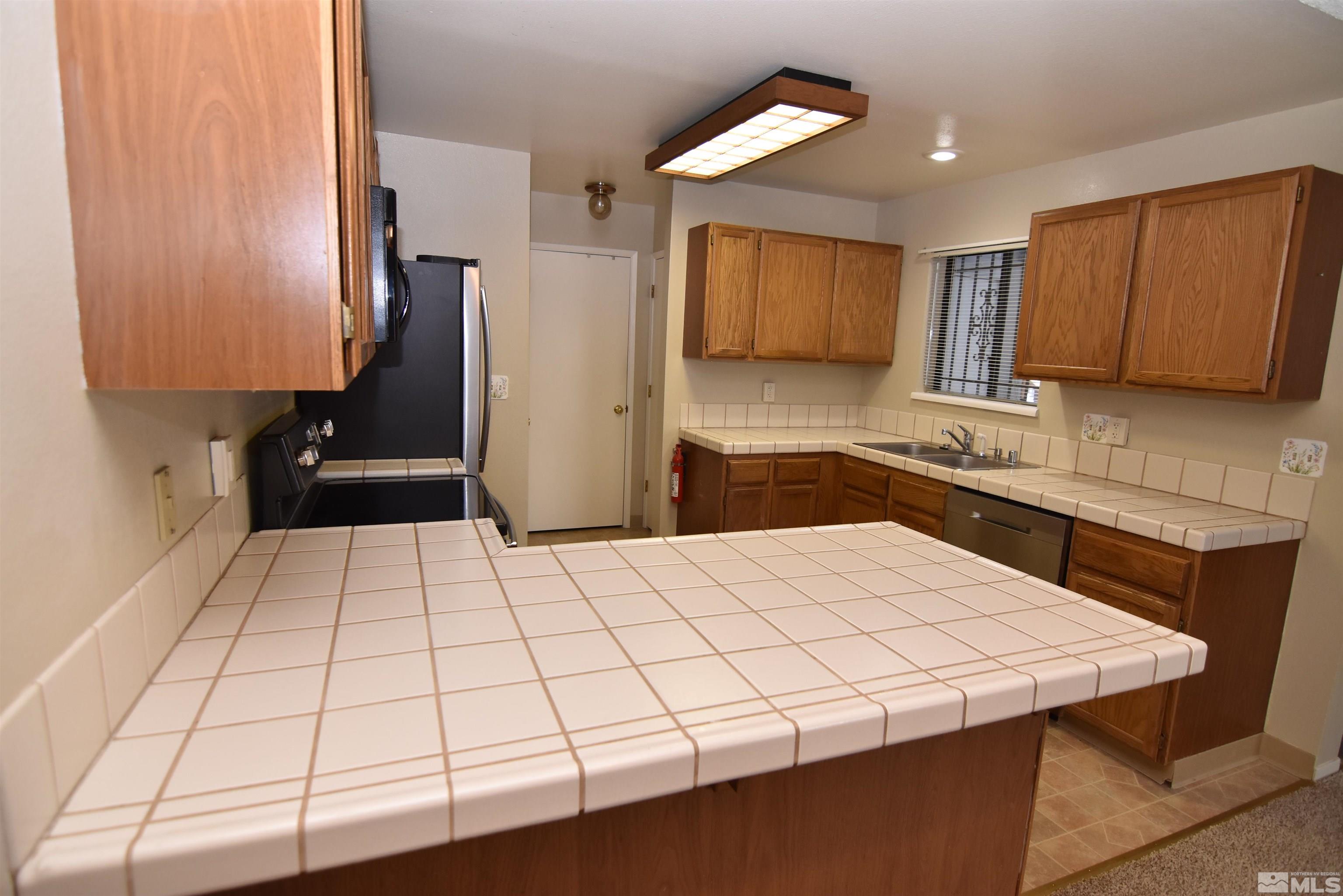 3945 Kings Row Reno, NV 89503 - Photo 6 of 19 a kitchen with a sink and a refrigerator