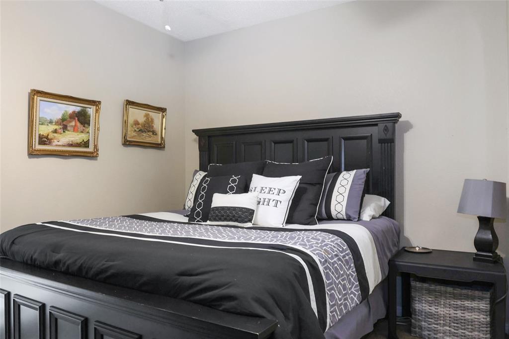 613 Regina Drive Hewitt, TX 76643 - Photo 17 of 33 a bed sitting in a bedroom next to a lamp
