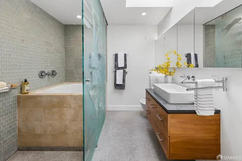 a bathroom with a sink mirror toilet and shower