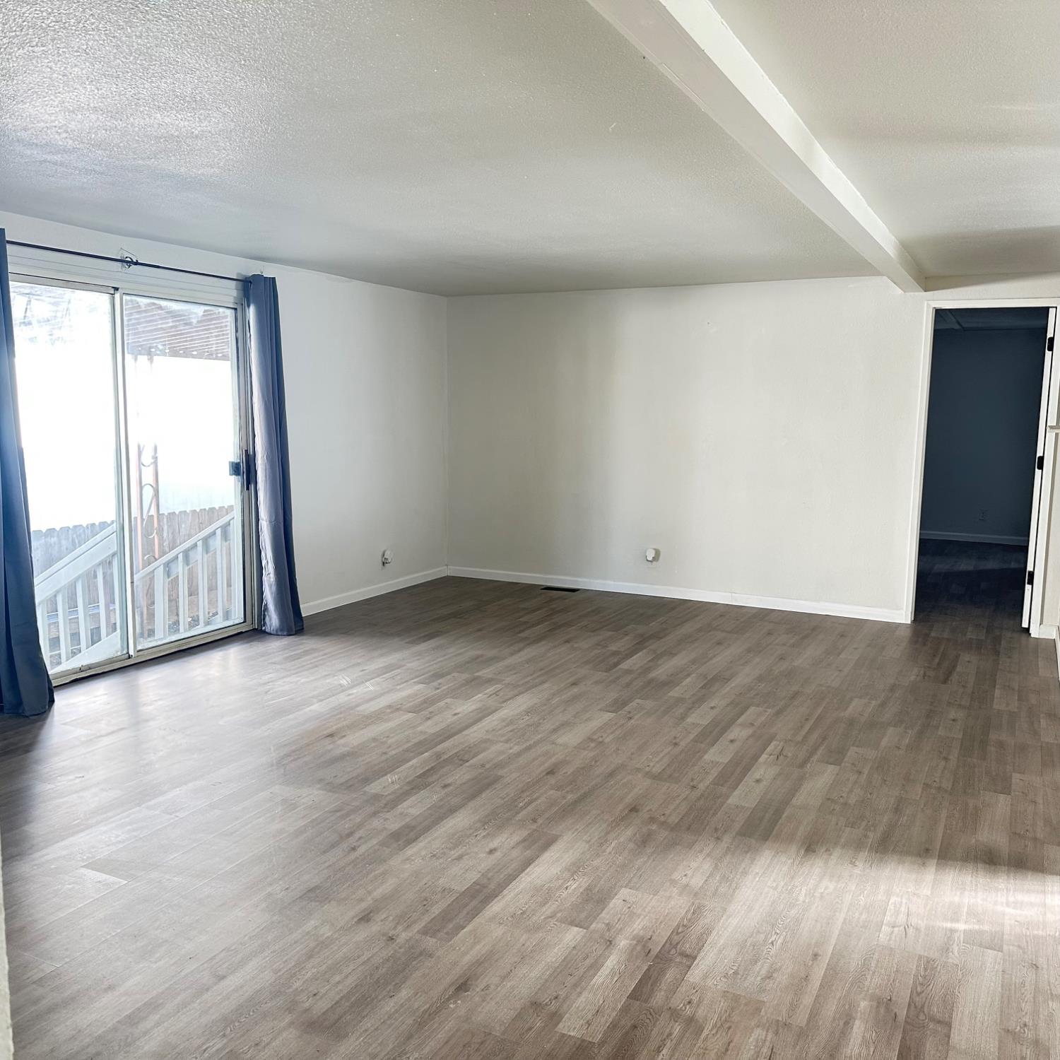 812 West Clover Road, Unit 66 Tracy, CA 95376 - Photo 5 of 27 an empty room with wooden floor and windows