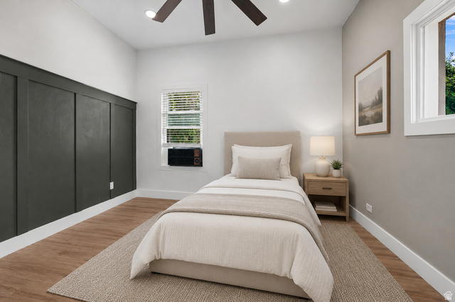 327 35th Street Ogden, UT 84401 - Photo 20 of 31 Bedroom featuring a decorative board and batten accent wall, wood-finish flooring, and a ceiling fan with integrated lighting
