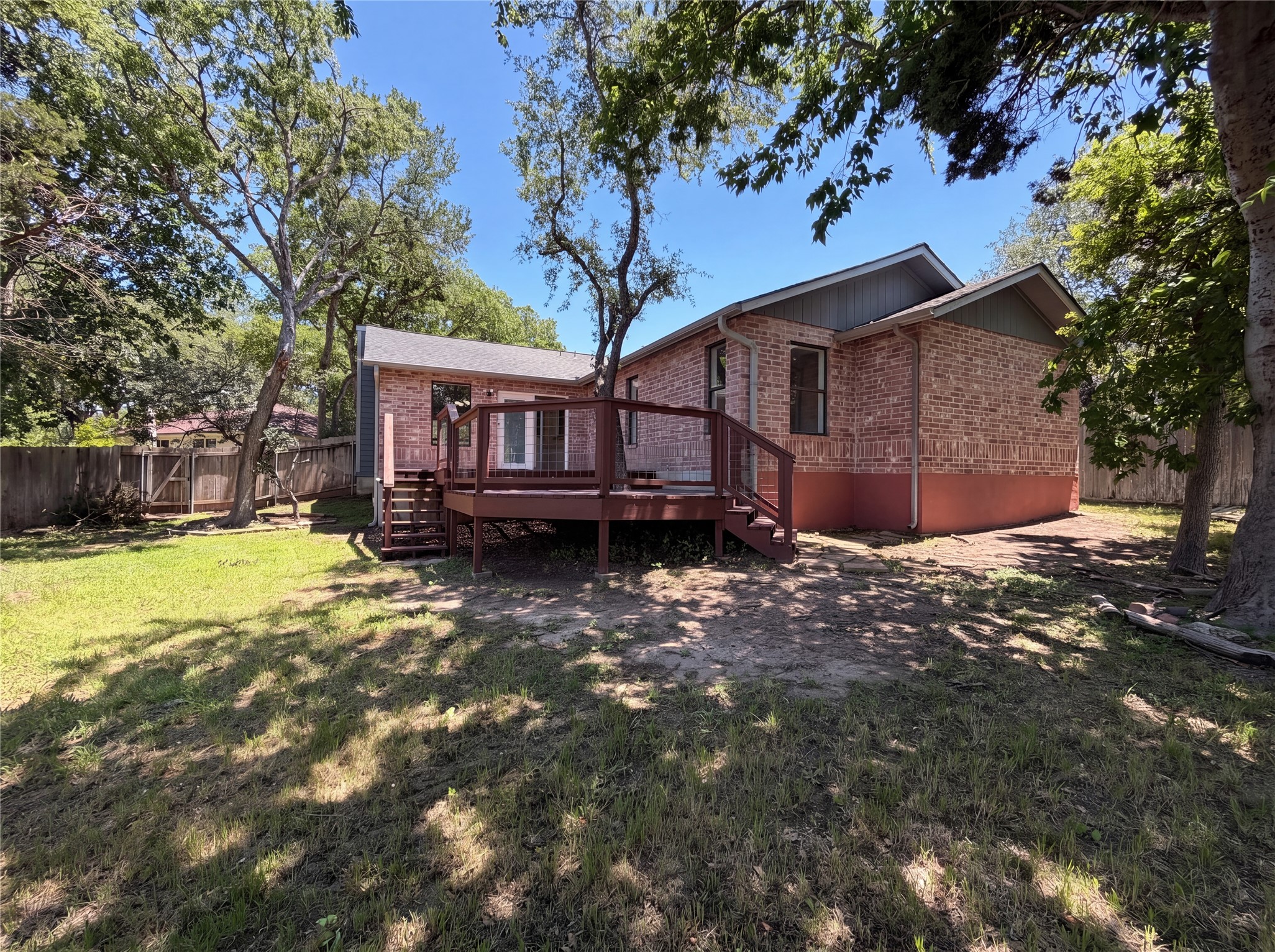 1111 North Riviera Circle Cedar Park, TX 78613 - Photo 5 of 17 Expansive rear yard featuring a multi-level wood deck with railings, mature trees, and a wooden privacy fence
