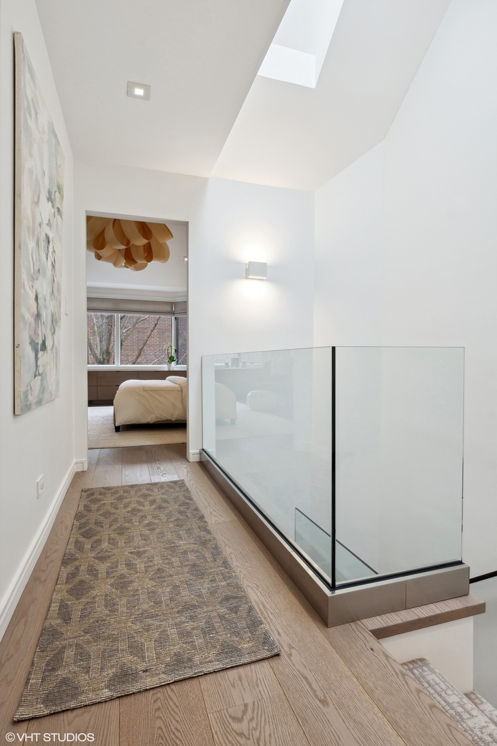 55 West Goethe Street, Unit 1223 Chicago, IL 60610 - Photo 13 of 31 a view of a bedroom with wooden floor and windows