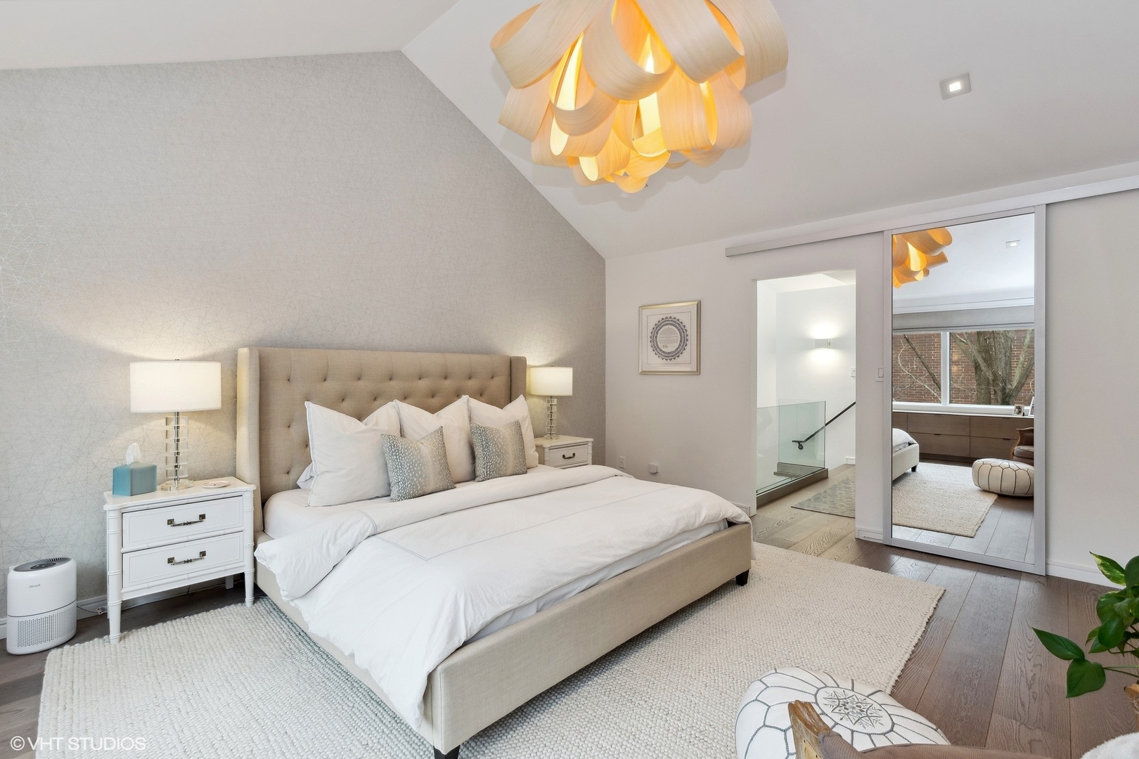55 West Goethe Street, Unit 1223 Chicago, IL 60610 - Photo 16 of 31 a bedroom with a bed and a chandelier