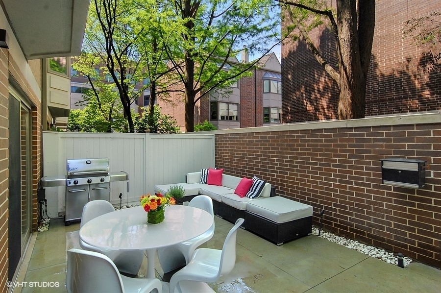 55 West Goethe Street, Unit 1223 Chicago, IL 60610 - Photo 27 of 31 a outdoor sitting area with furniture and a fireplace