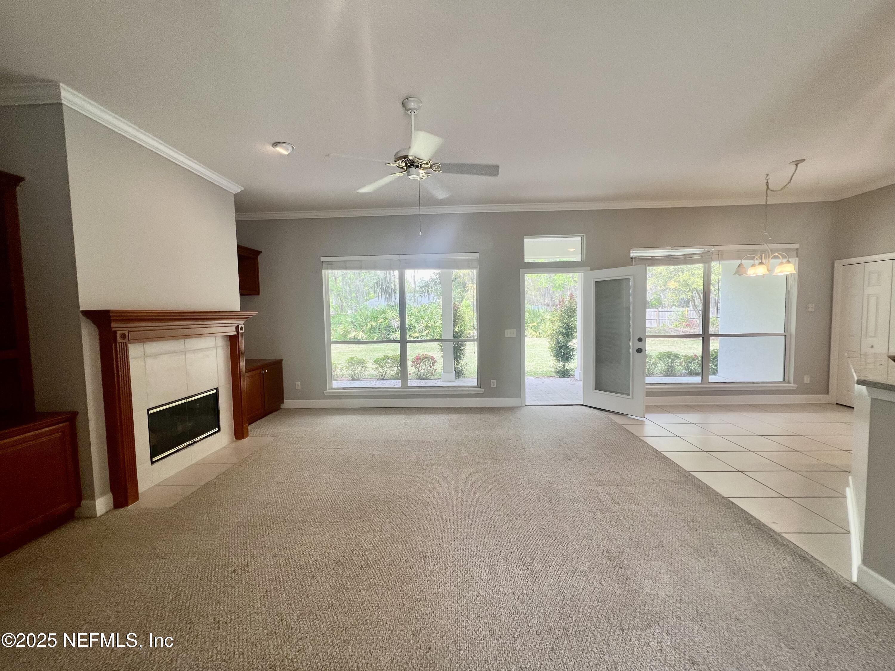 2284 Emilys Way Fleming Island, FL 32003 - Photo 14 of 36 a view of an empty room with a fireplace and a window