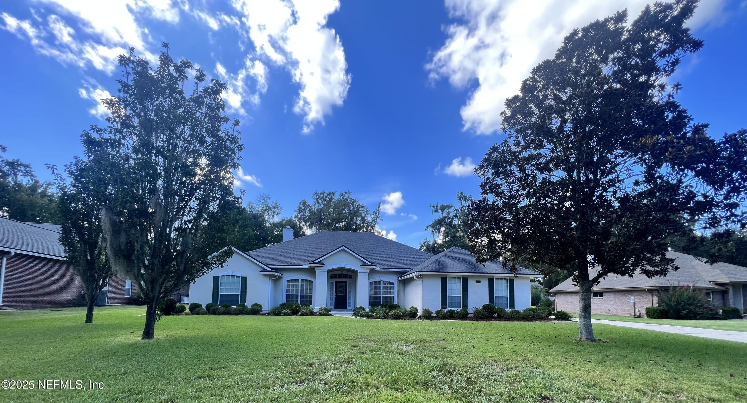 2284 Emilys Way Fleming Island, FL 32003 - Photo 2 of 36 a front view of a house with garden