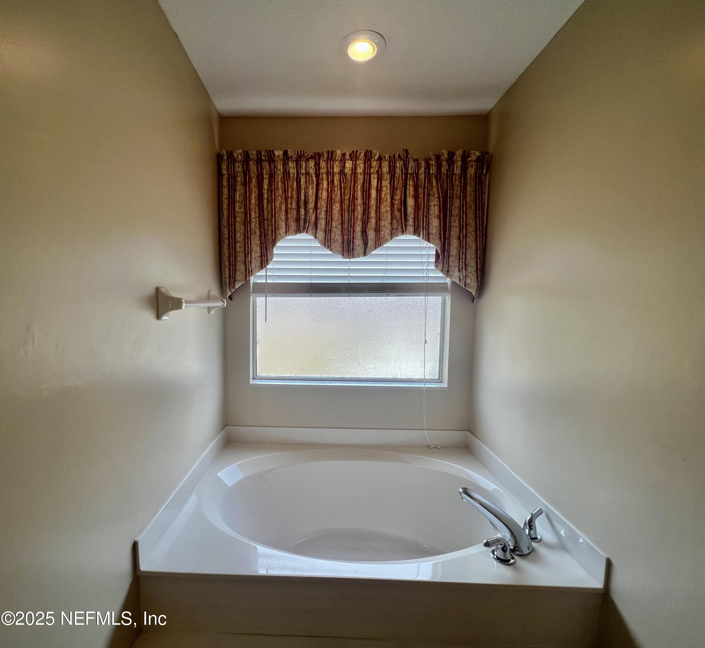 2284 Emilys Way Fleming Island, FL 32003 - Photo 22 of 36 a bathroom with a tub and a window