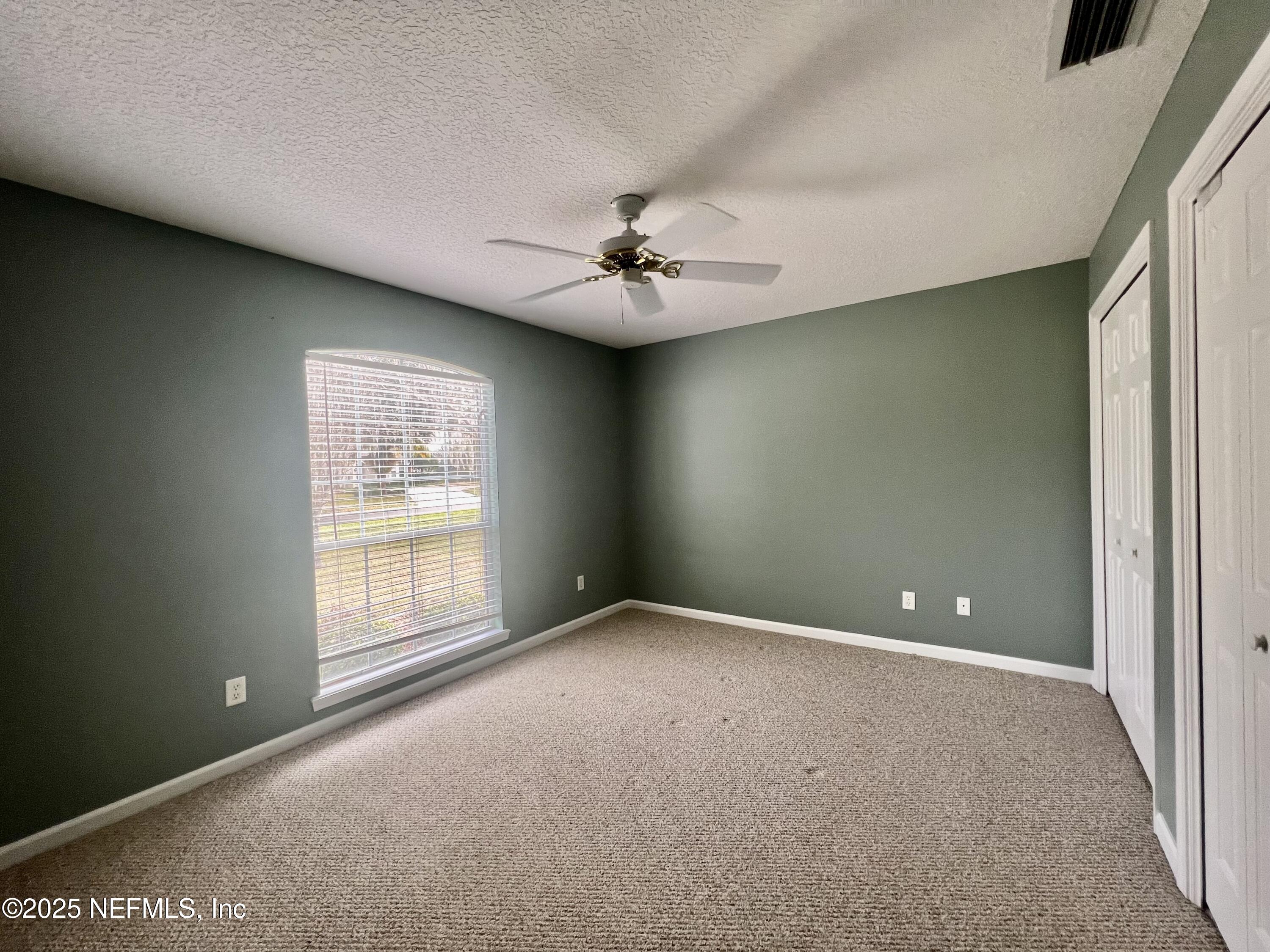 2284 Emilys Way Fleming Island, FL 32003 - Photo 24 of 36 a view of an empty room with a window