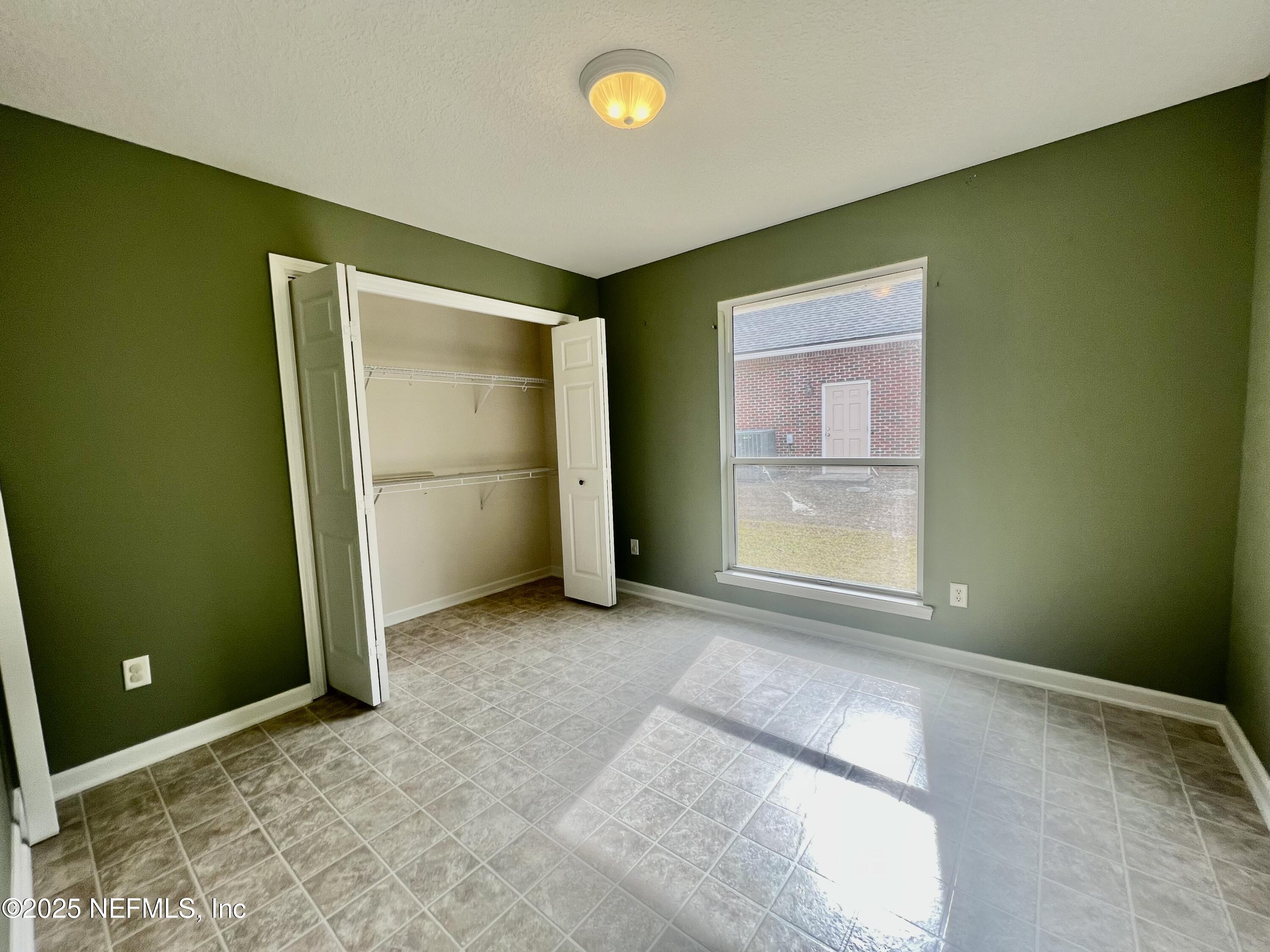 2284 Emilys Way Fleming Island, FL 32003 - Photo 27 of 36 an empty room with windows and closet