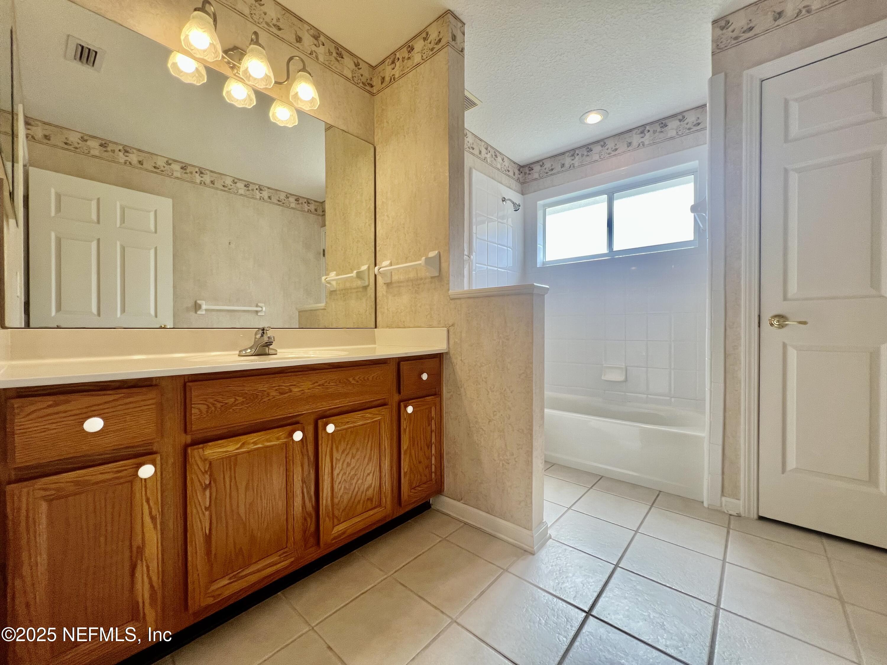 2284 Emilys Way Fleming Island, FL 32003 - Photo 29 of 36 a bathroom with a sink vanity and mirror
