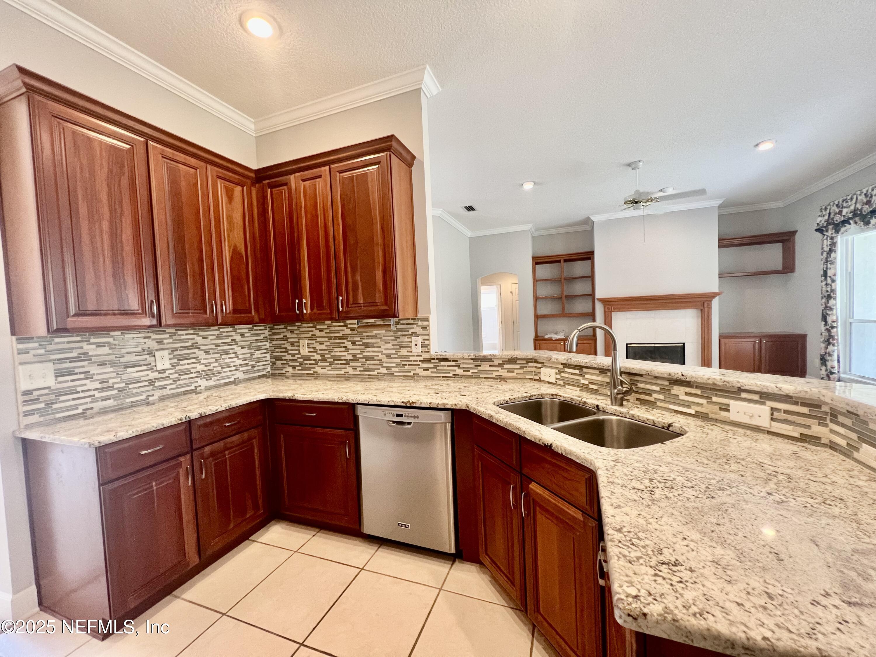 2284 Emilys Way Fleming Island, FL 32003 - Photo 7 of 36 a kitchen with a sink stove and cabinets