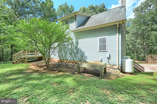 a view of a house with a yard porch and sitting area