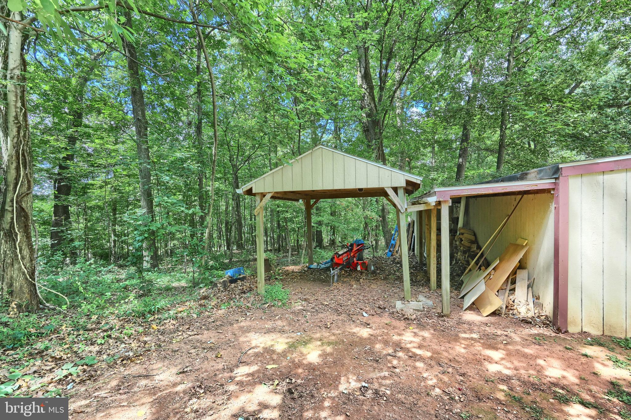 6031 Mountain Road Dover, PA 17315 - Photo 18 of 47 a view of a backyard with a table and chairs under an umbrella