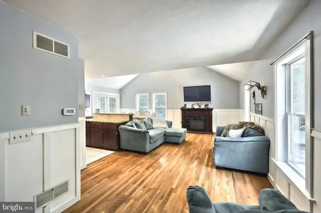 a living room with furniture and a hallway