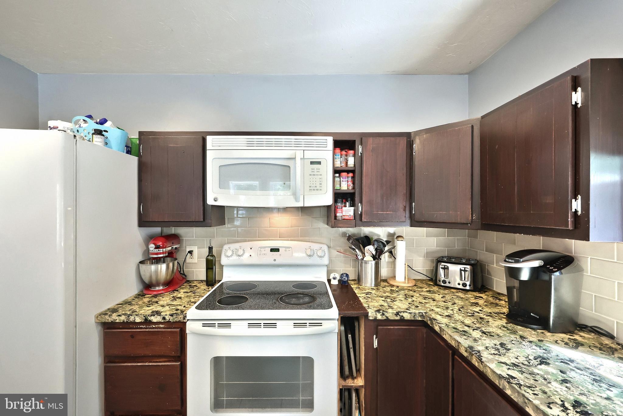 6031 Mountain Road Dover, PA 17315 - Photo 27 of 47 a kitchen with a stove top oven a sink a refrigerator and cabinets
