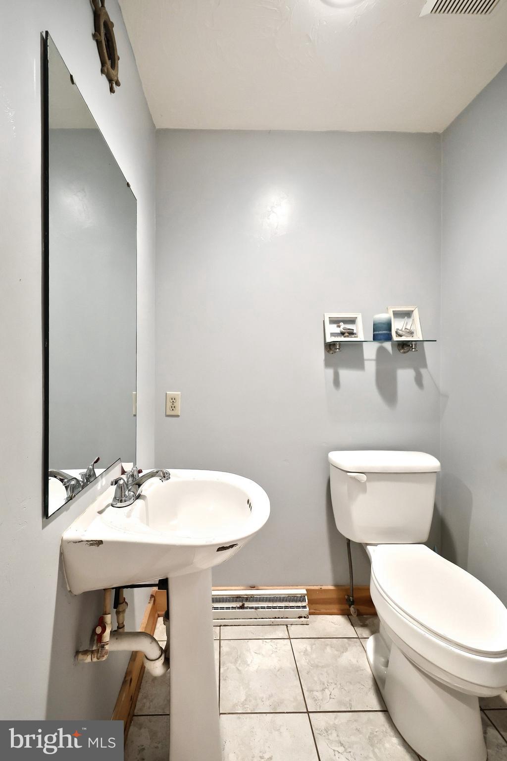 6031 Mountain Road Dover, PA 17315 - Photo 28 of 47 a bathroom with a toilet a sink and mirror