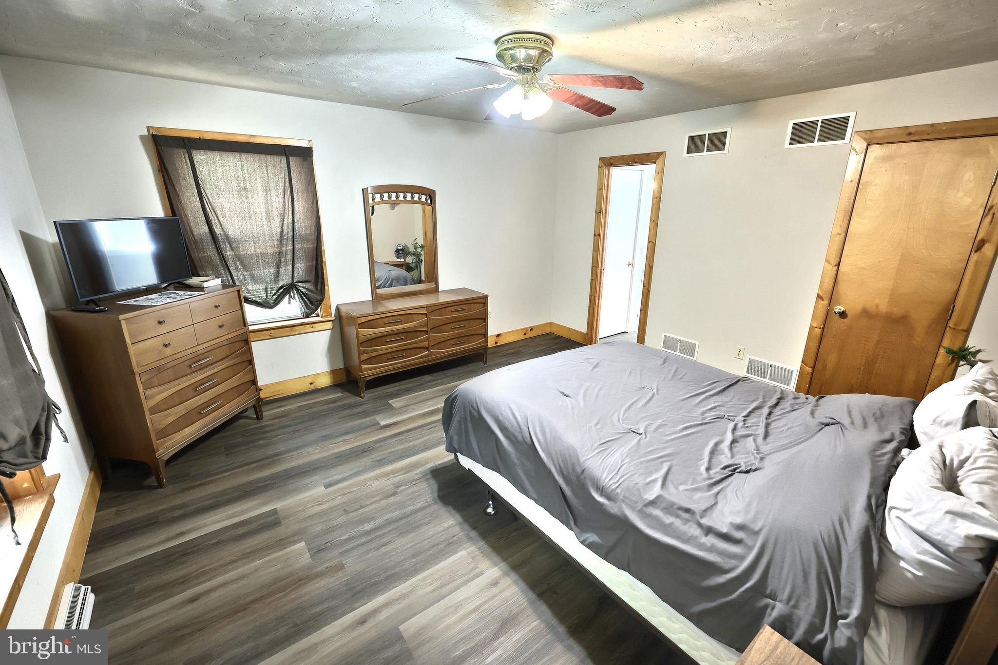 6031 Mountain Road Dover, PA 17315 - Photo 29 of 47 a bedroom with a bed and wooden floor