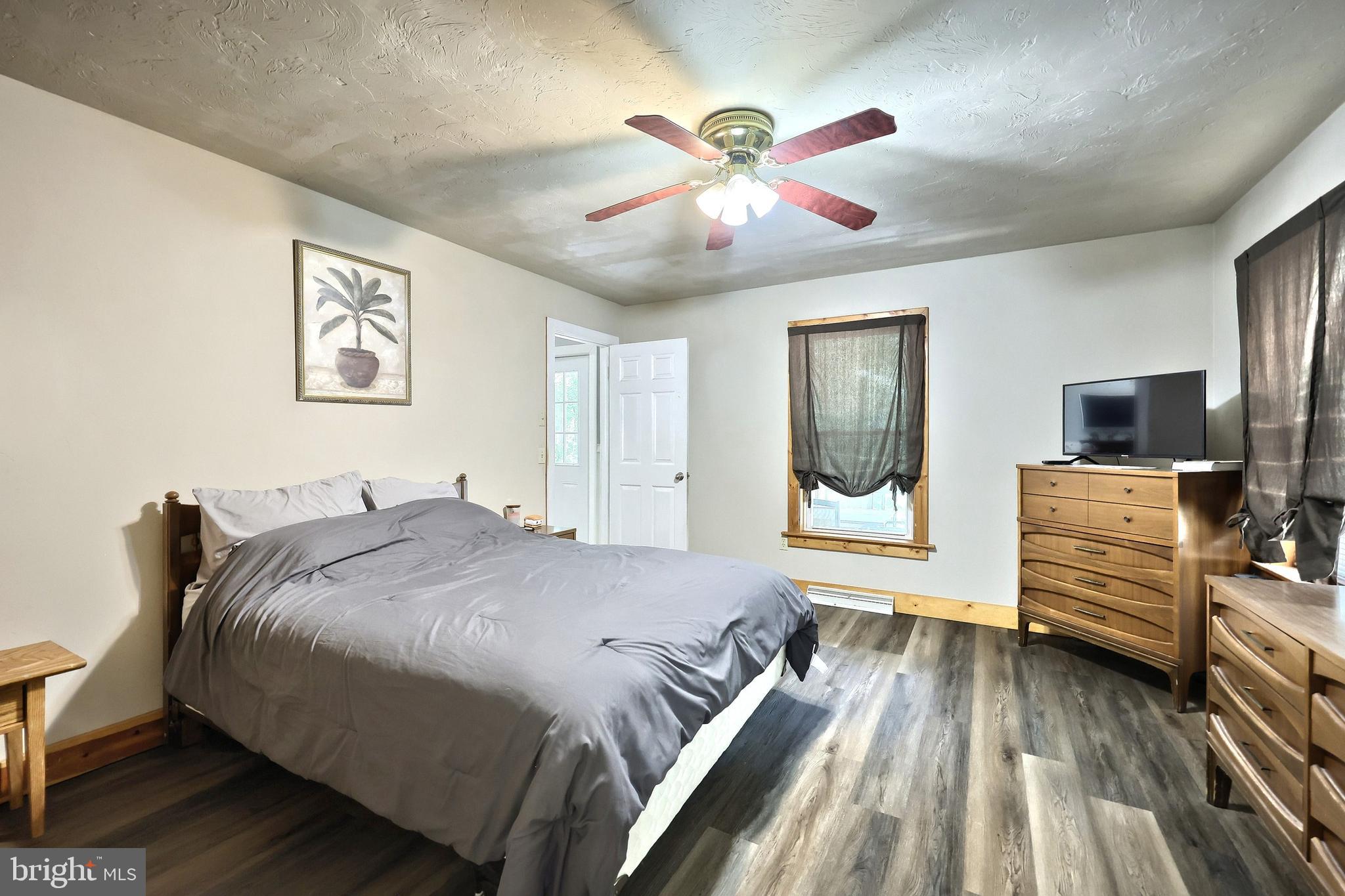 6031 Mountain Road Dover, PA 17315 - Photo 30 of 47 a bedroom with a bed and wooden floor