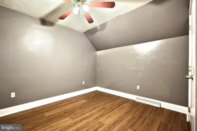 a spacious bedroom with a bed and a cabinets