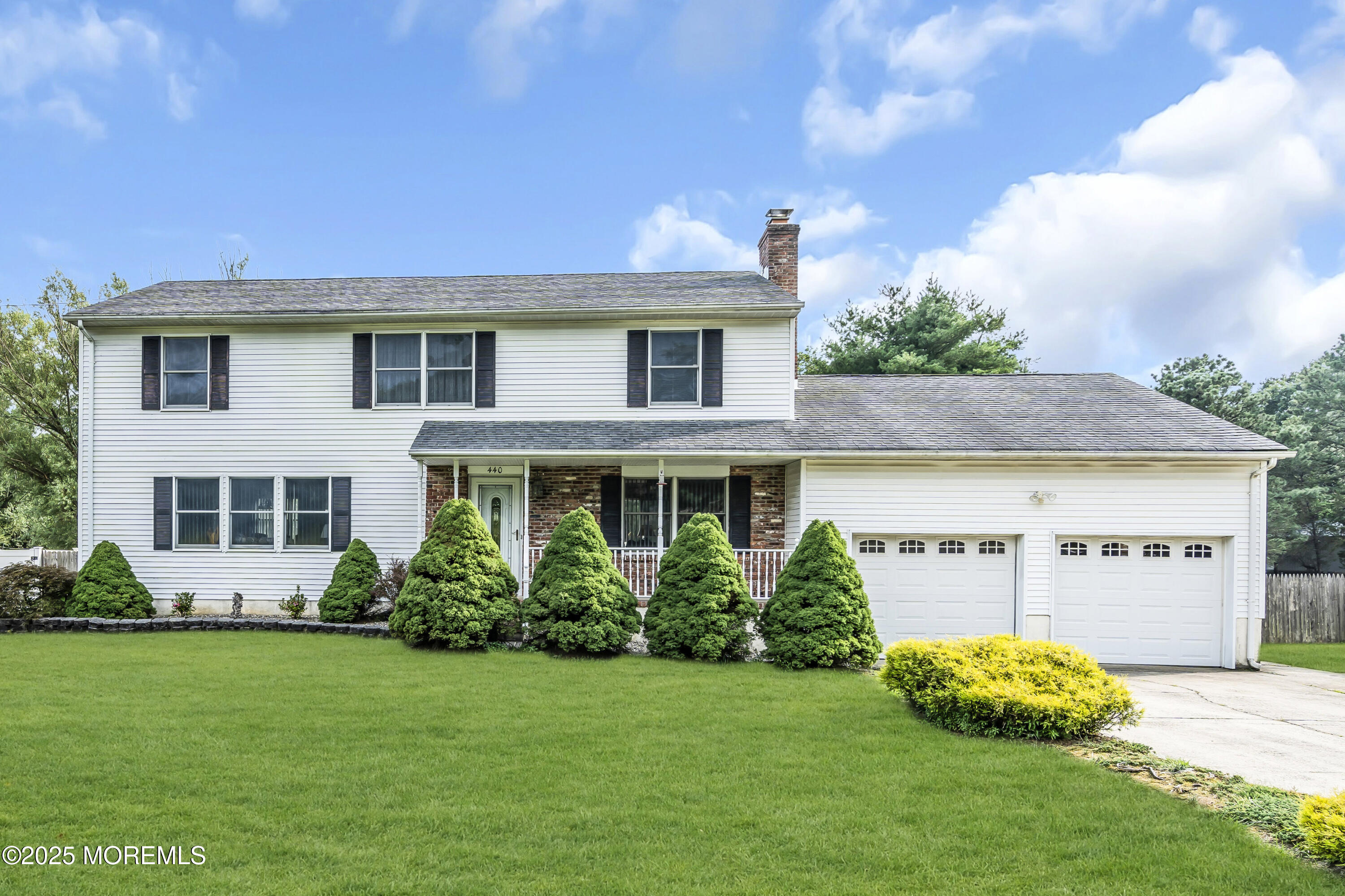 a front view of a house with a garden