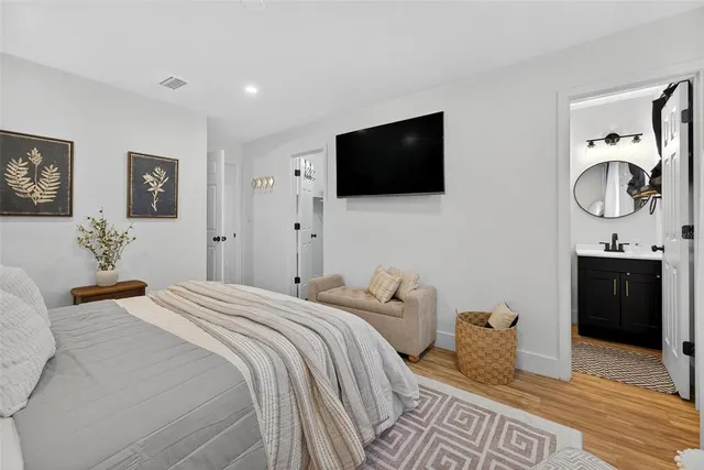 a view of a yard with plants and large trees