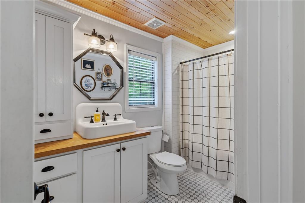 2700 Jack Glass Road Monroe, GA 30656 - Photo 17 of 48 a bathroom with a toilet sink vanity and mirror