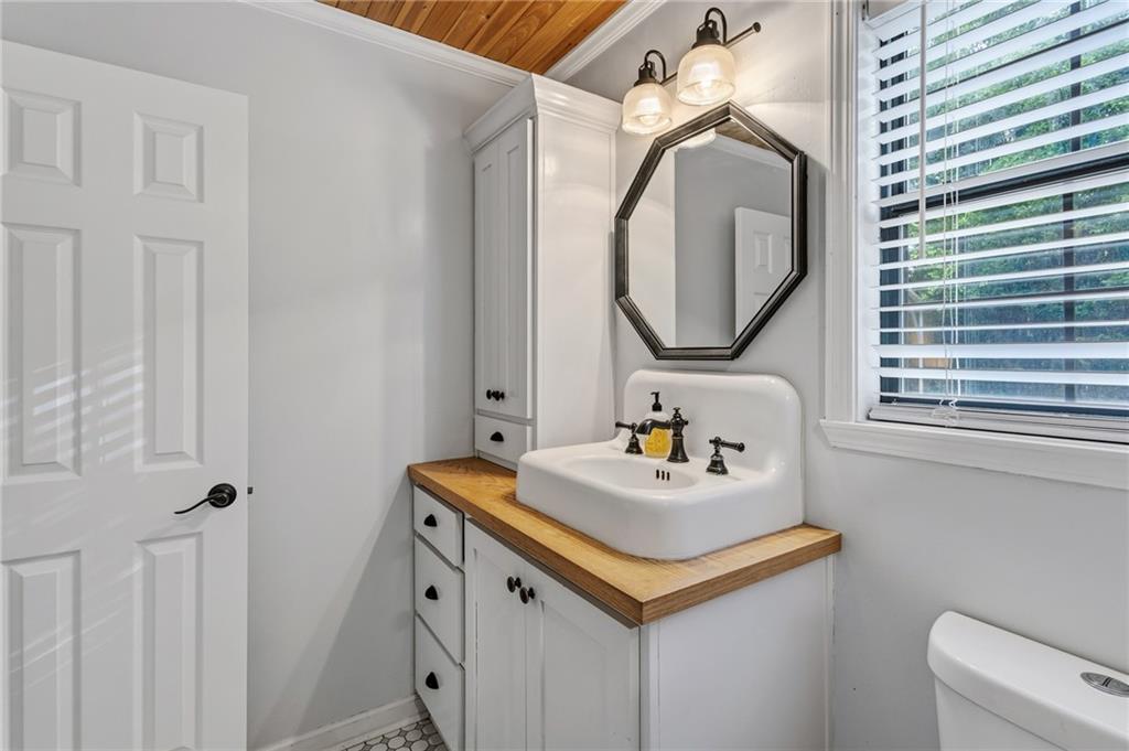 2700 Jack Glass Road Monroe, GA 30656 - Photo 18 of 48 a bathroom with a sink and a mirror
